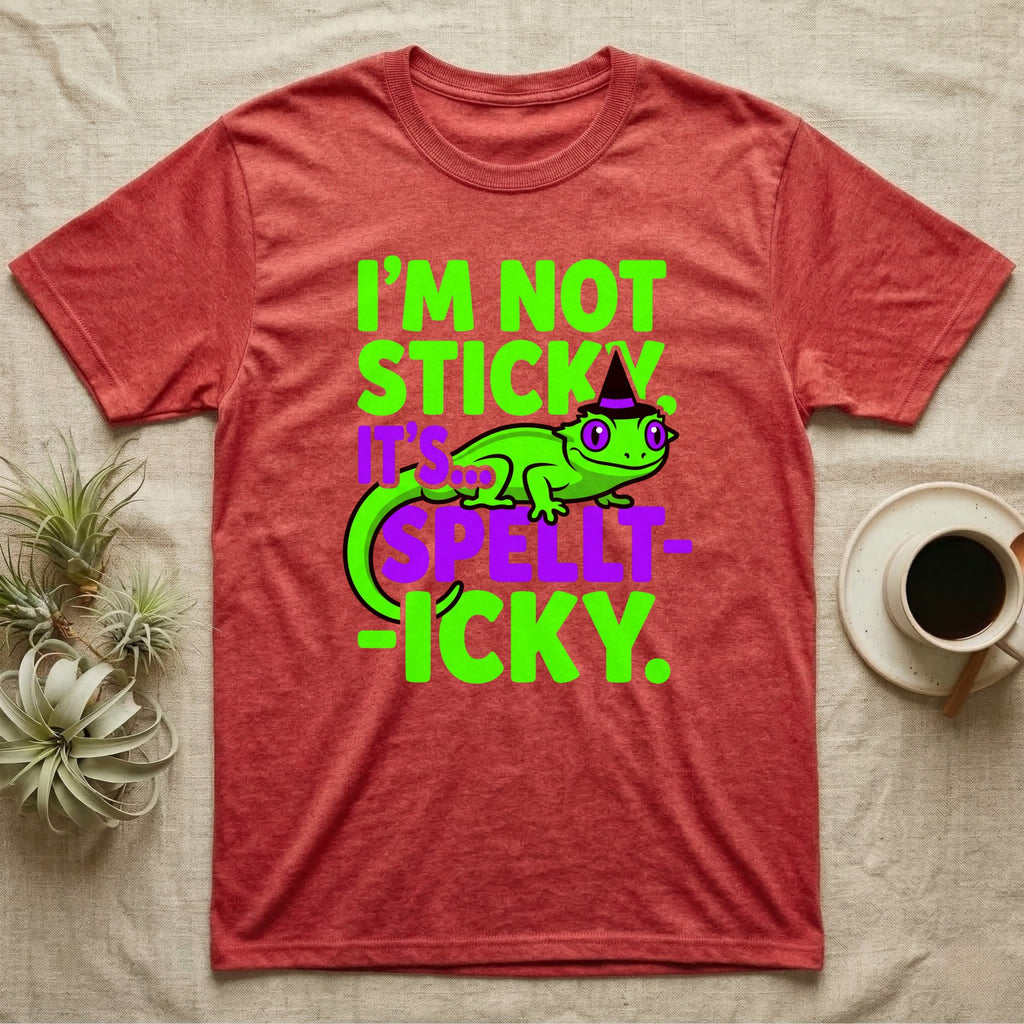 Crested Gecko Spellt-icky T-Shirt in Heather Red — Neon cartoon crested gecko in a witch hat with stacked text, "I'm Not Sticky, It's Spellt-icky."
