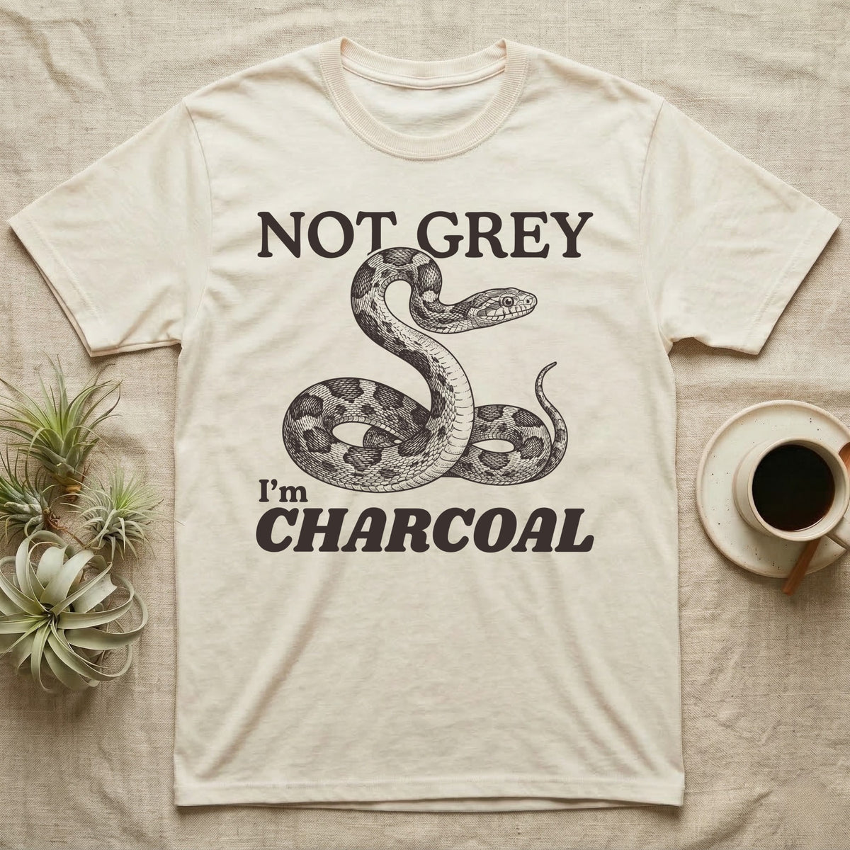 Charcoal Corn Snake T-Shirt in Natural — Engraved grey corn snake reared back in an S-curve under dark lettering reading NOT GREY, I'm CHARCOAL