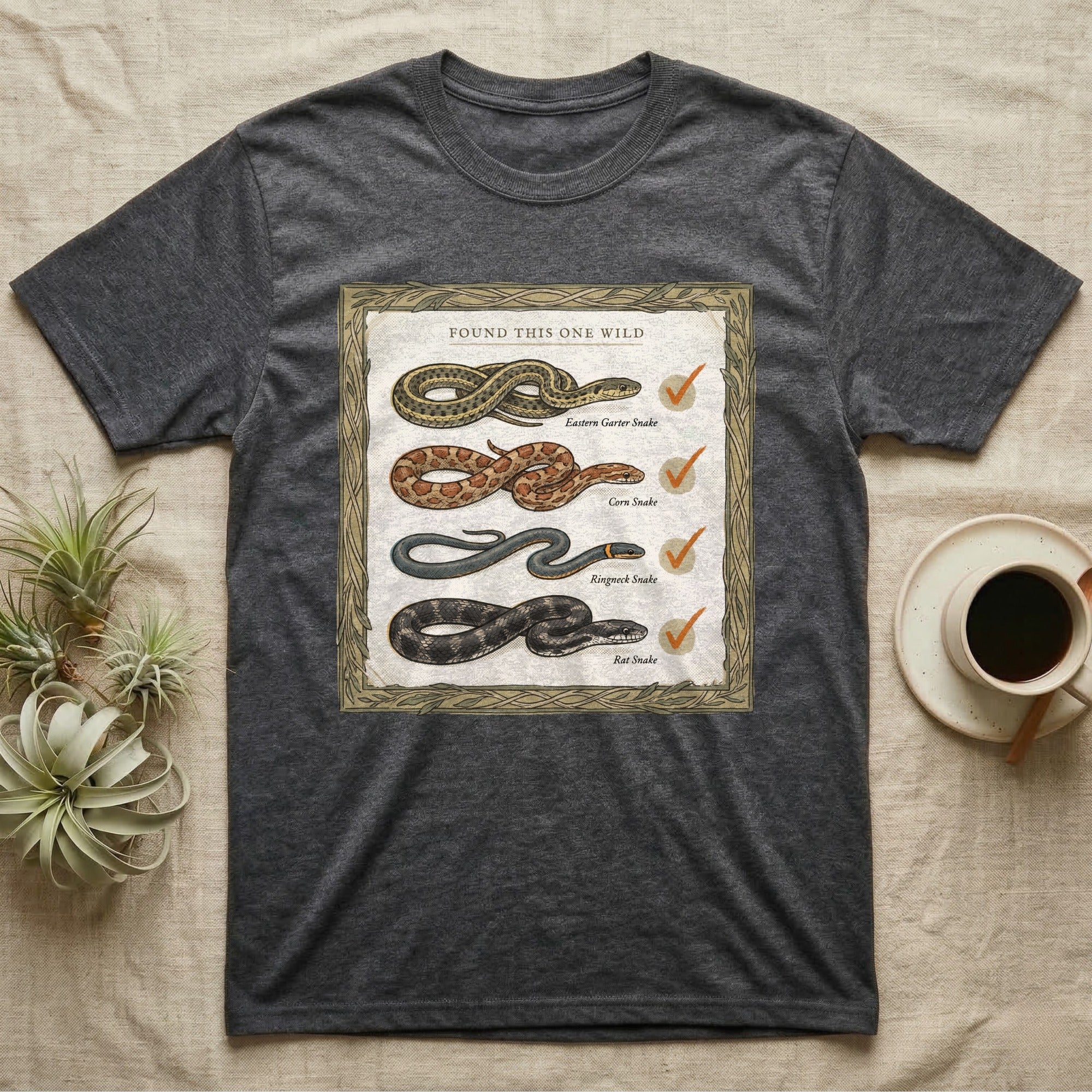 Native Snake Life List T-Shirt in Dark Heather — Vintage field-guide life list of native snakes drawn as small specimens with tally checkmarks beside each.