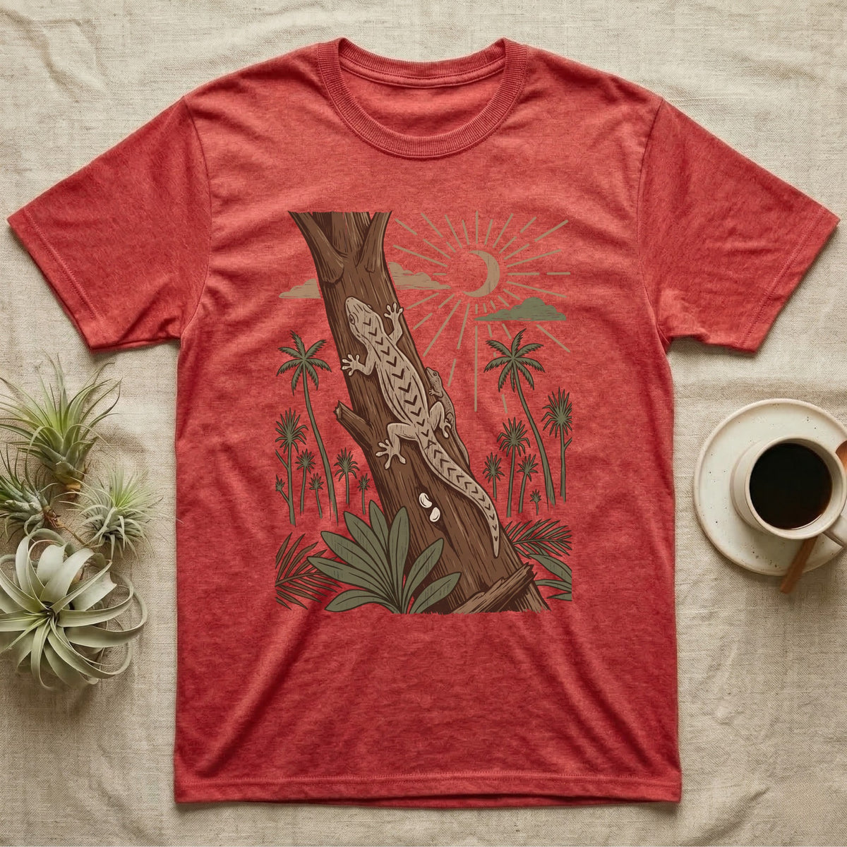Mourning Gecko Home Range T-Shirt in Heather Red — Woodcut-style illustration of two mourning geckos on a palm trunk with a pair of eggs in the bark and palms behind, no on-shirt text.
