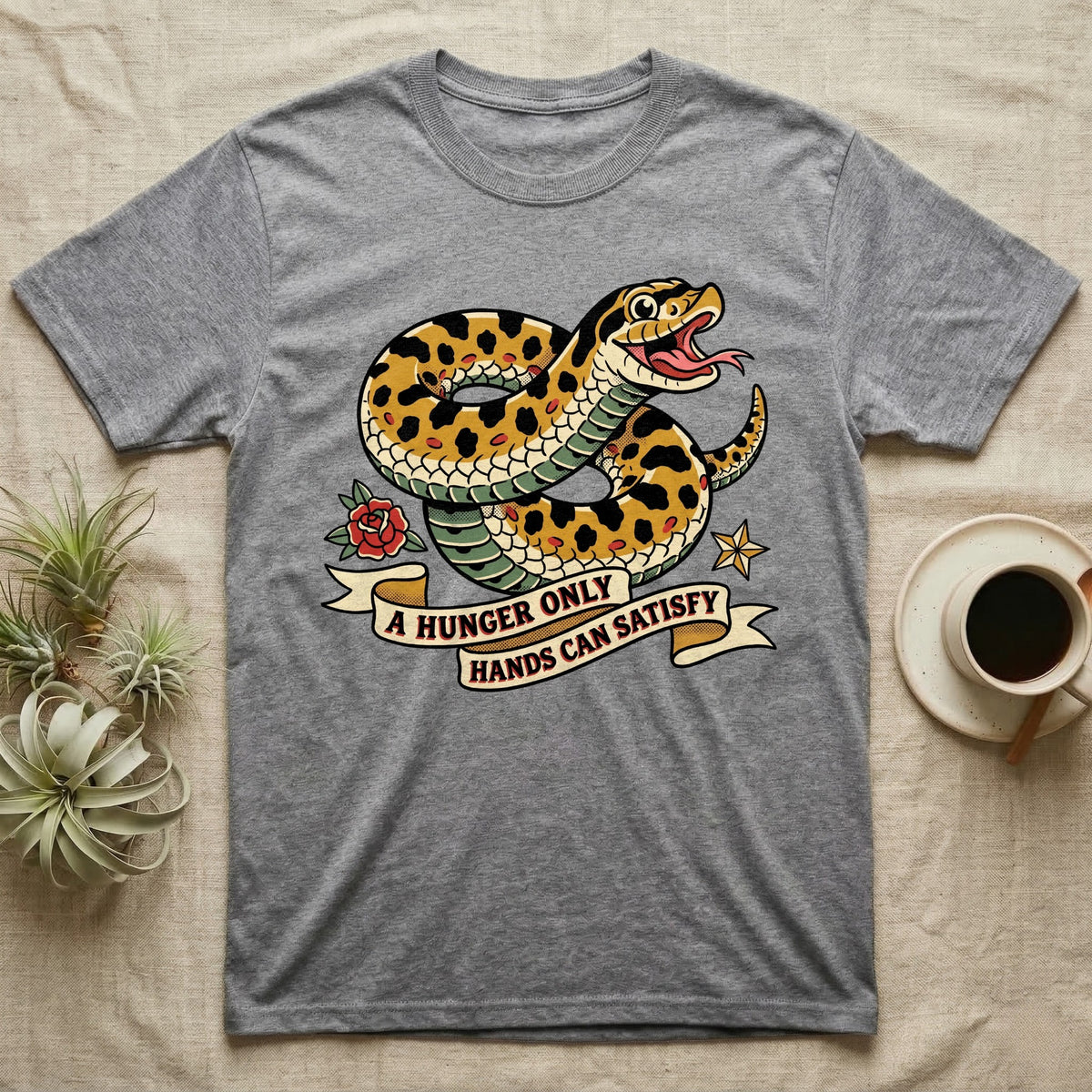 Hognose Hunger Flash T-Shirt in Sport Grey — American-traditional tattoo-flash illustration of a hognose snake in a heroic coil with a banner reading the feeding-hunger line.