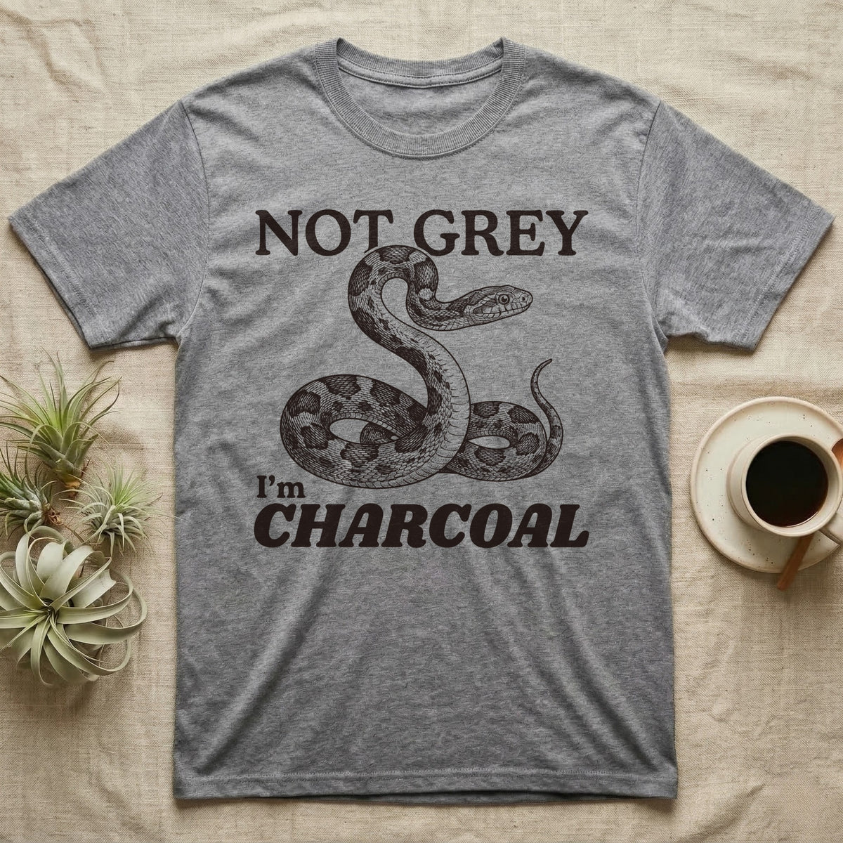 Charcoal Corn Snake T-Shirt in Sport Grey — Engraved grey corn snake reared back in an S-curve under dark lettering reading NOT GREY, I'm CHARCOAL