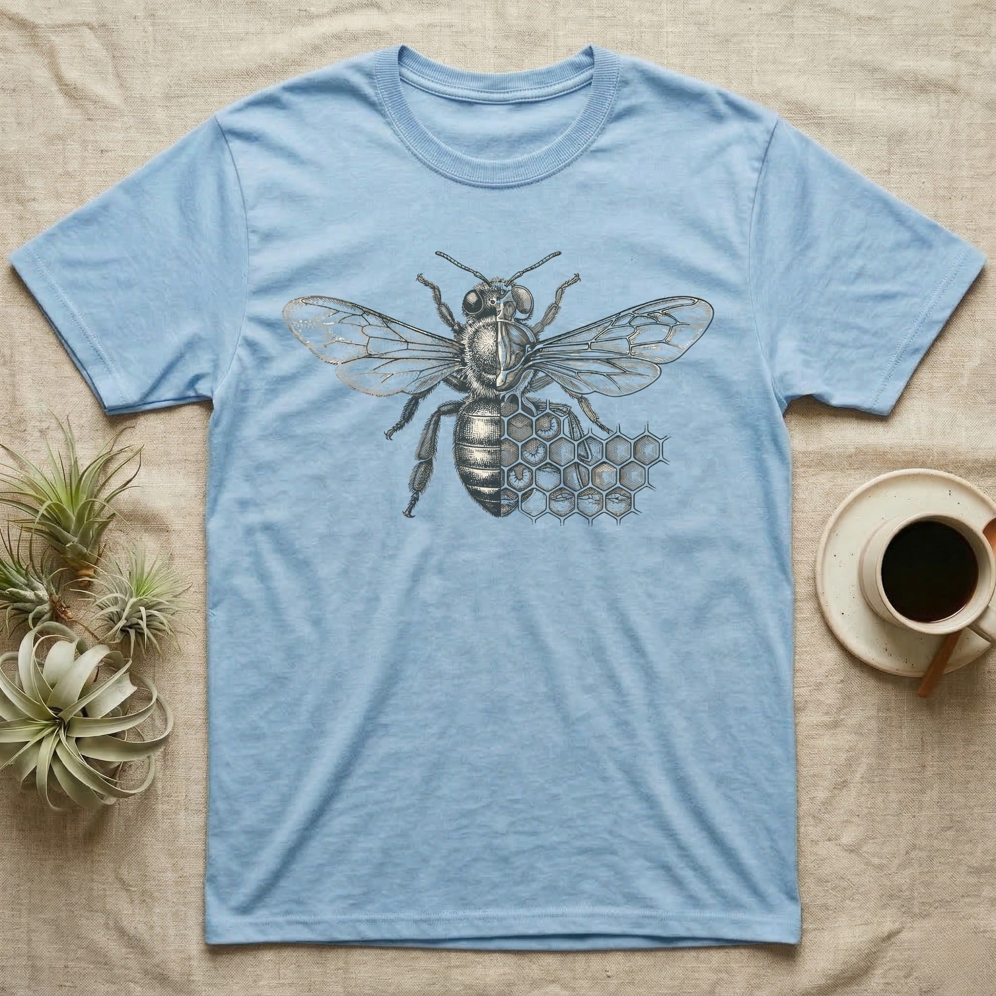 Light blue t-shirt with a vintage bee and honeycomb graphic.
