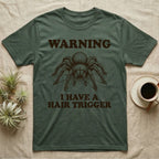Tarantula Hair Trigger T-Shirt in Military Green — Engraved curly hair tarantula, front legs half-raised, with the words Warning, I Have a Hair Trigger