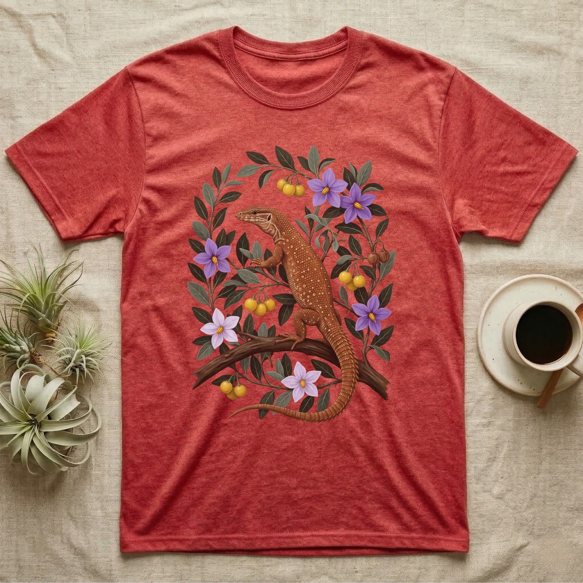 Ackie Monitor Botanical T-Shirt in Heather Red — Naturalist oil painting of a red ackie monitor on a branch inside an oval bower of bush tomato with violet flowers and yellow fruit.