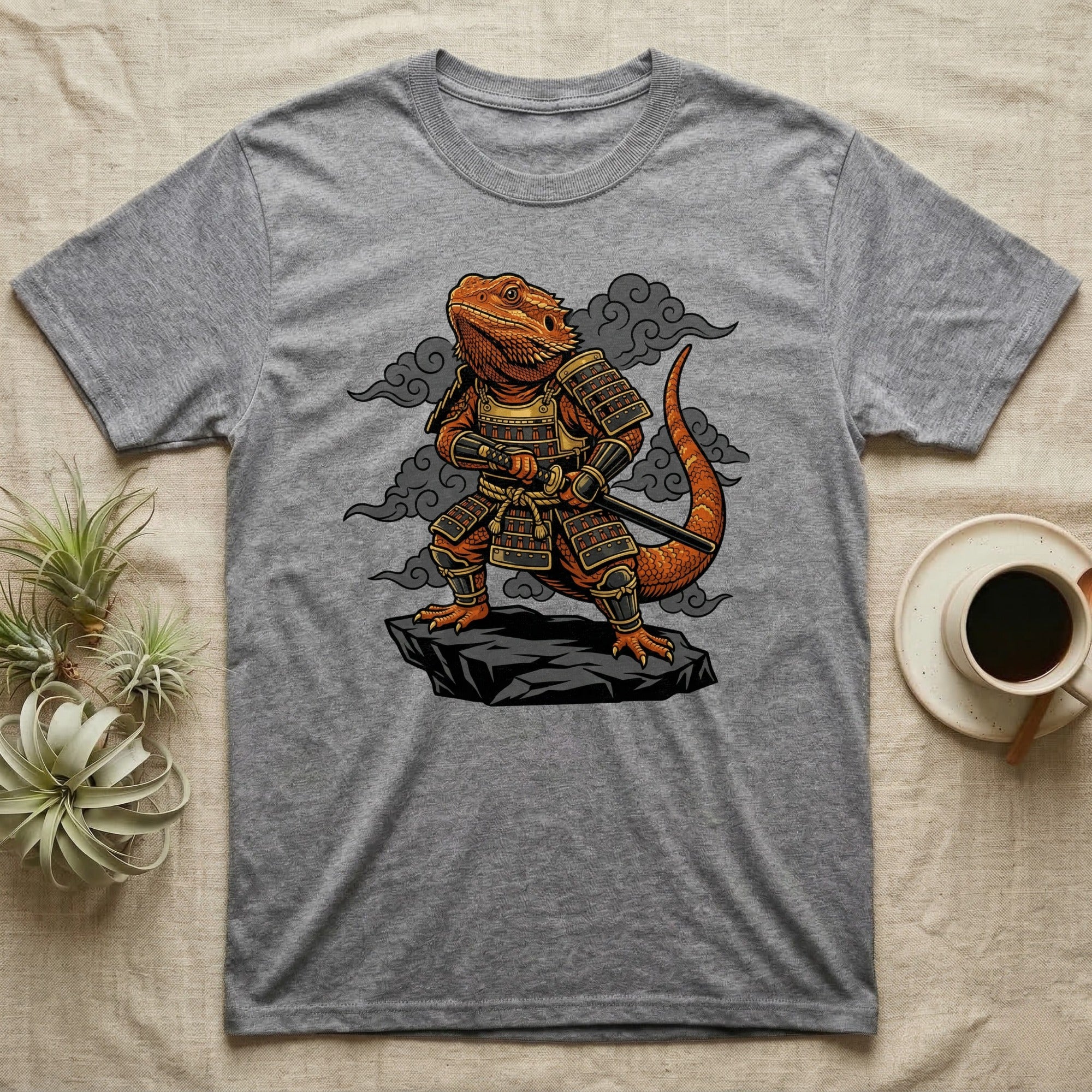 Grey t-shirt with a samurai lizard illustration against a cloudy background.