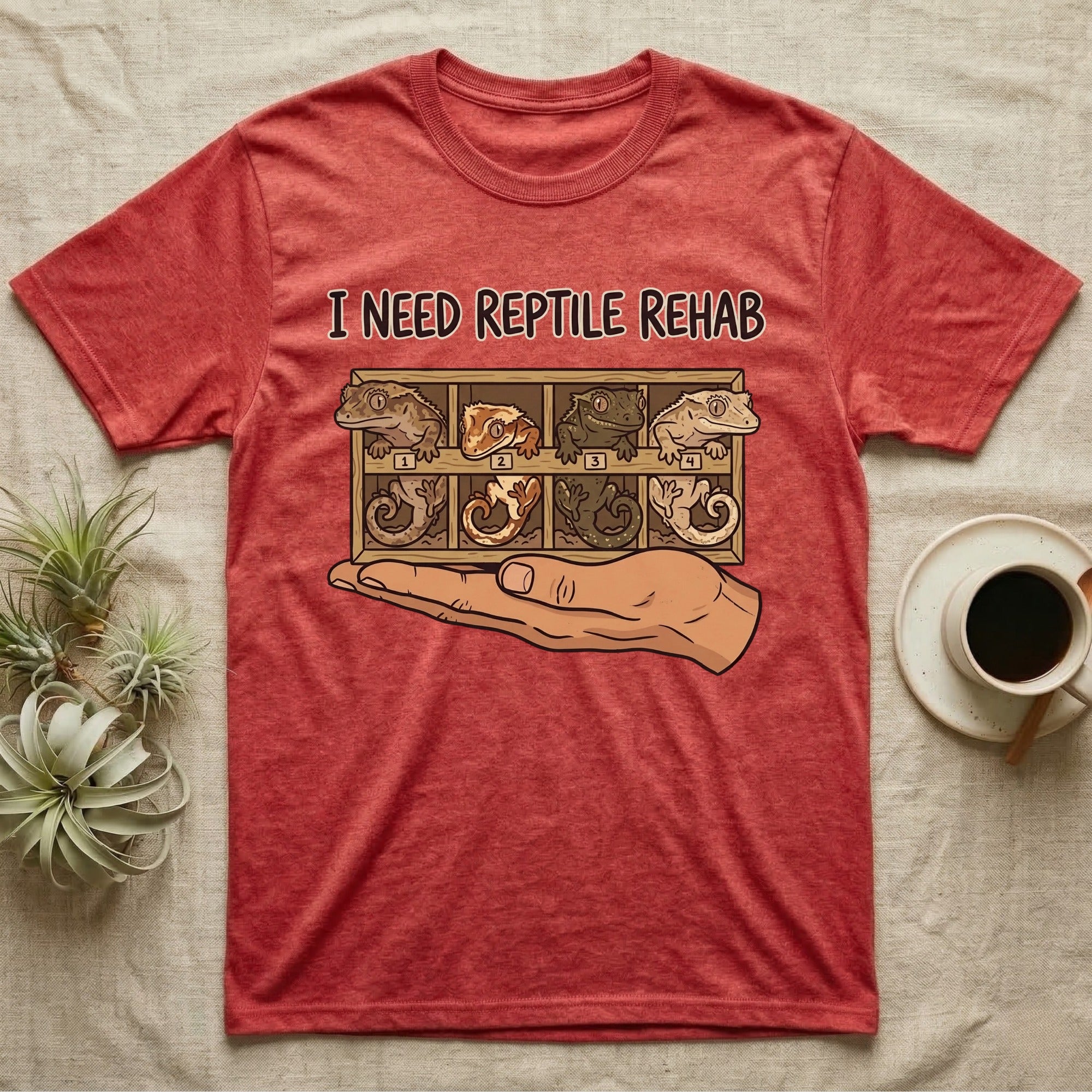 Crested Gecko Rehab T-Shirt in Heather Red — Vector scene of a hand presenting a rack of four crested geckos under a marker-style reptile rehab caption.