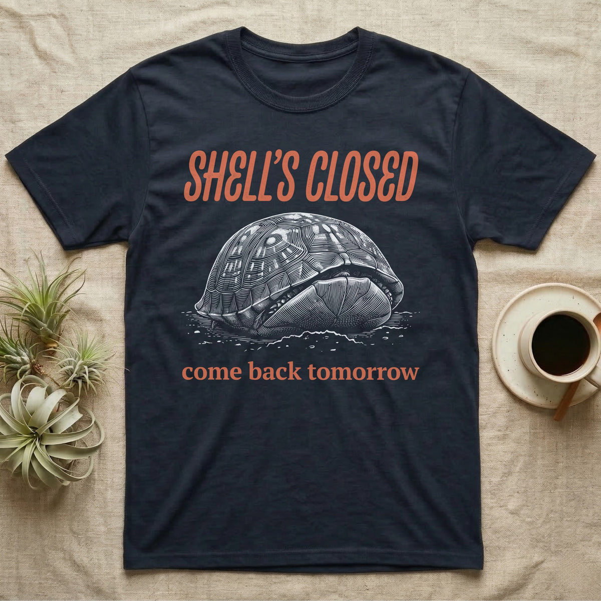Box Turtle Shell's Closed T-Shirt in Navy — Engraved white-line eastern box turtle shut tight under retro orange script reading SHELL'S CLOSED, come back tomorrow.