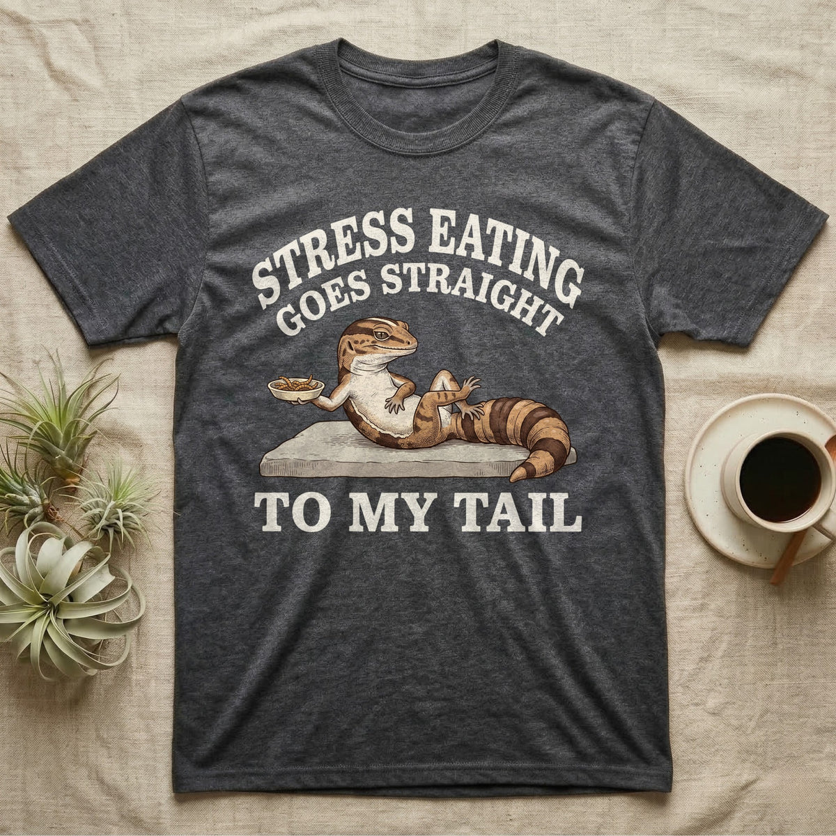 Fat-Tailed Gecko Snacking T-Shirt in Dark Heather — Engraved fat-tailed gecko lounging on a stone with mealworms under Stress Eating Goes Straight To My Tail