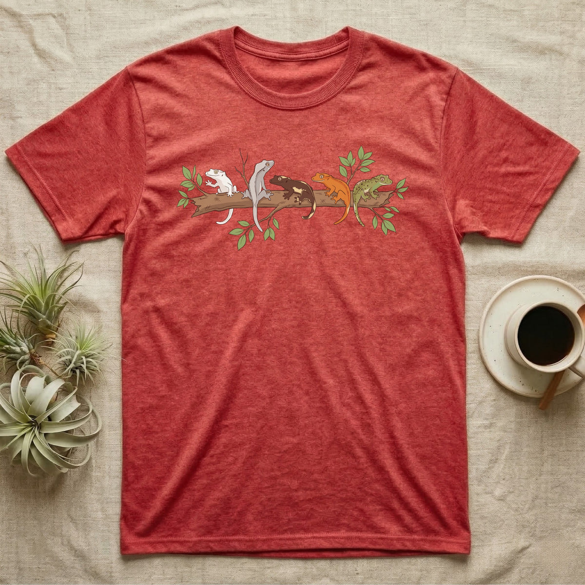 Crested Gecko Morph Line T-Shirt in Heather Red — Five crested gecko morphs in ink and watercolour perched along one cork bark branch with ficus leaves.