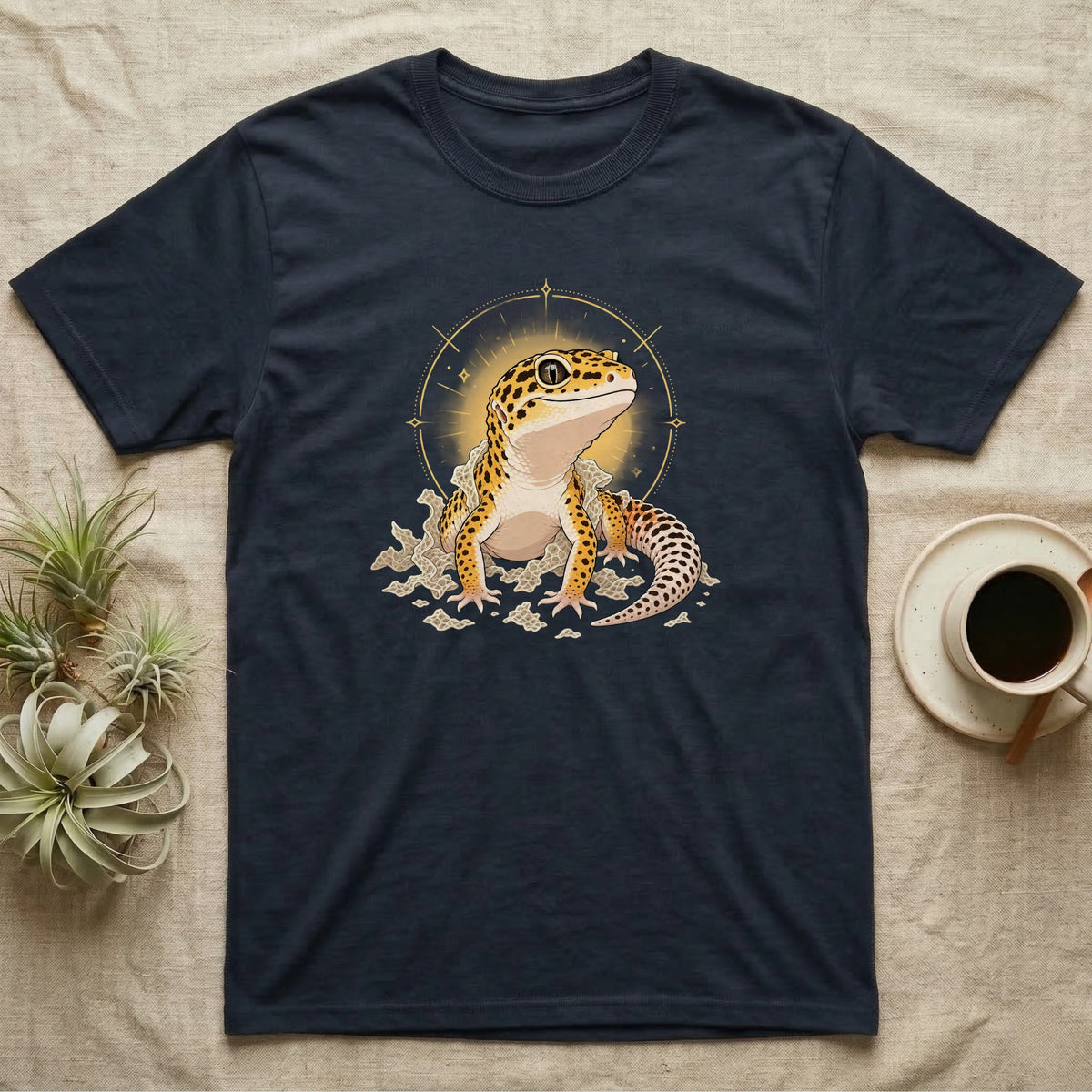 Leopard Gecko Shed T-Shirt in Navy — Bold vector illustration of a leopard gecko emerging fresh from a shed, lit by a soft warm halo glow.