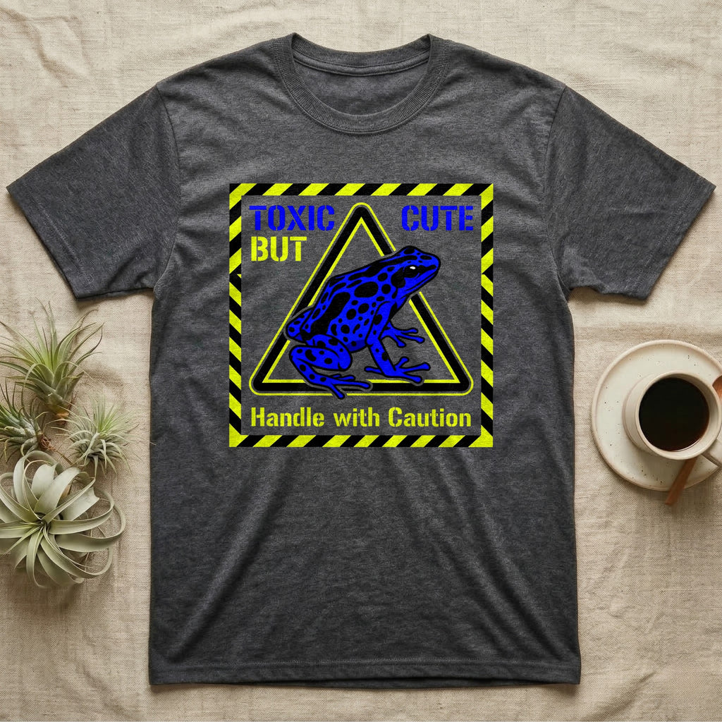 Dark grey t-shirt with blue poison dart frog graphic and "TOXIC BUT CUTE" text.