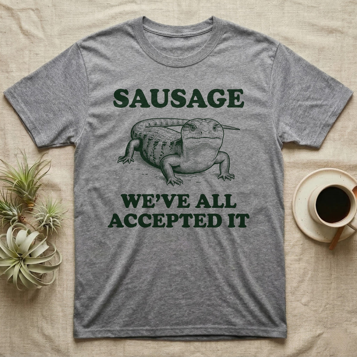Blue Tongue Skink Sausage T-Shirt in Sport Grey — Antique-engraved blue-tongued skink facing forward, with the word SAUSAGE above and a two-line caption below.