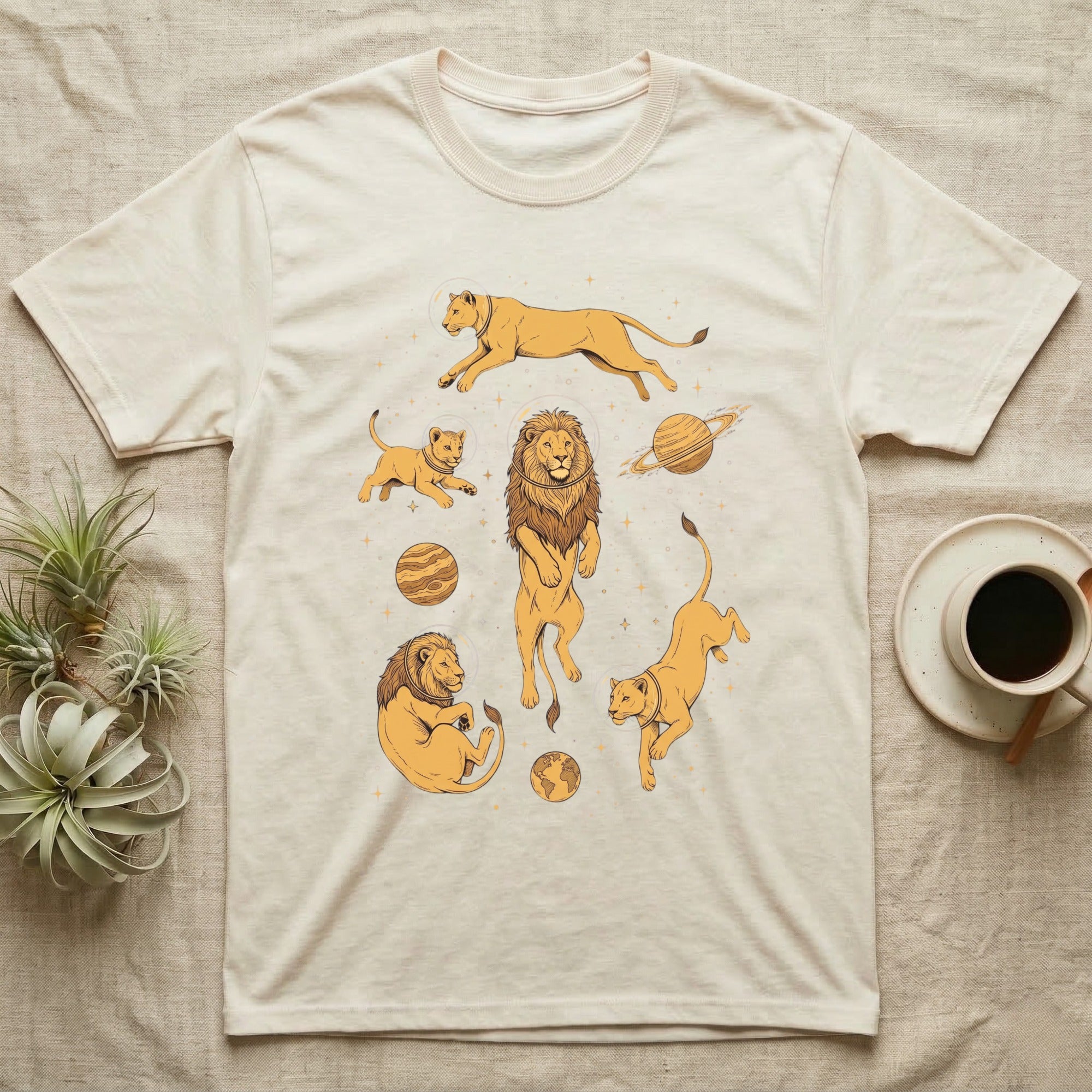 Cream t-shirt with line art illustrations of lions and planets in yellow.