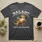 Bearded Dragon Standards T-Shirt in Dark Heather — Engraved bearded dragon in a camp chair holding greens topped with a hornworm under text Salad? Only With a Hornworm on Top