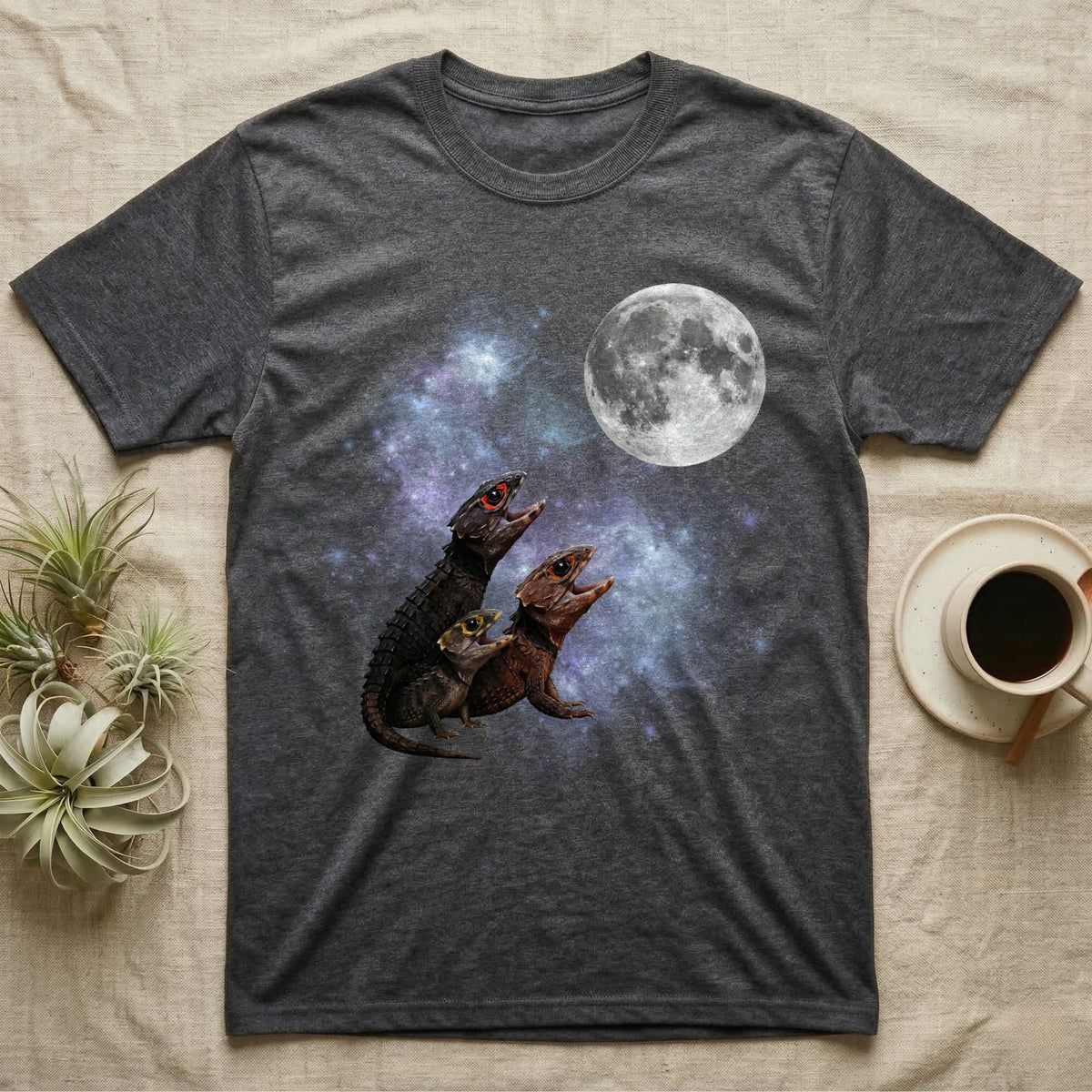 Red-Eyed Crocodile Skink Moon Howl T-Shirt in Dark Heather — Three Red-Eyed Crocodile Skink colour morphs howling at a full moon over a nebula on a dark grey t-shirt.