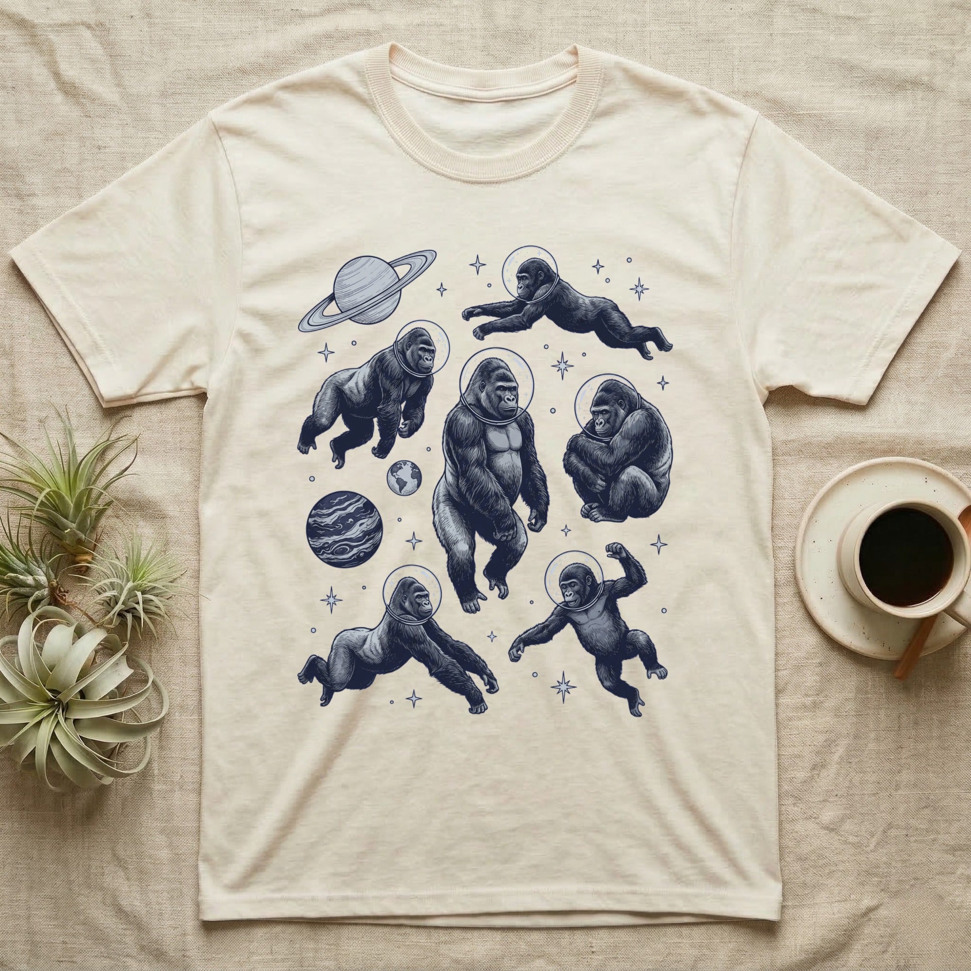 T-shirt with cartoon gorillas in space, planets, and stars.