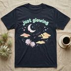 Emperor Scorpion Baby T-Shirt in Navy — Black emperor scorpion, pincers raised, under a pastel moon and stars with puffy mint bubble text "just glowing".