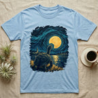 Hermann's Tortoise Moon T-Shirt in Light Blue — Painted Hermann's tortoise seen from behind, neck stretched up, biting a piece out of a golden spiral moon in a swirling blue night sky over a lake