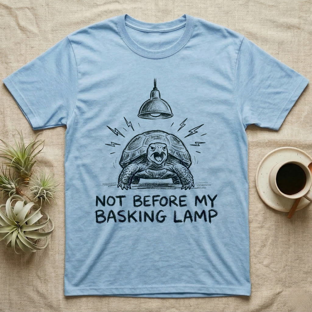 Russian Tortoise Mornings T-Shirt in Light Blue — Charcoal drawing of a grumpy Russian tortoise yelling up at a basking lamp above the words NOT BEFORE MY BASKING LAMP.