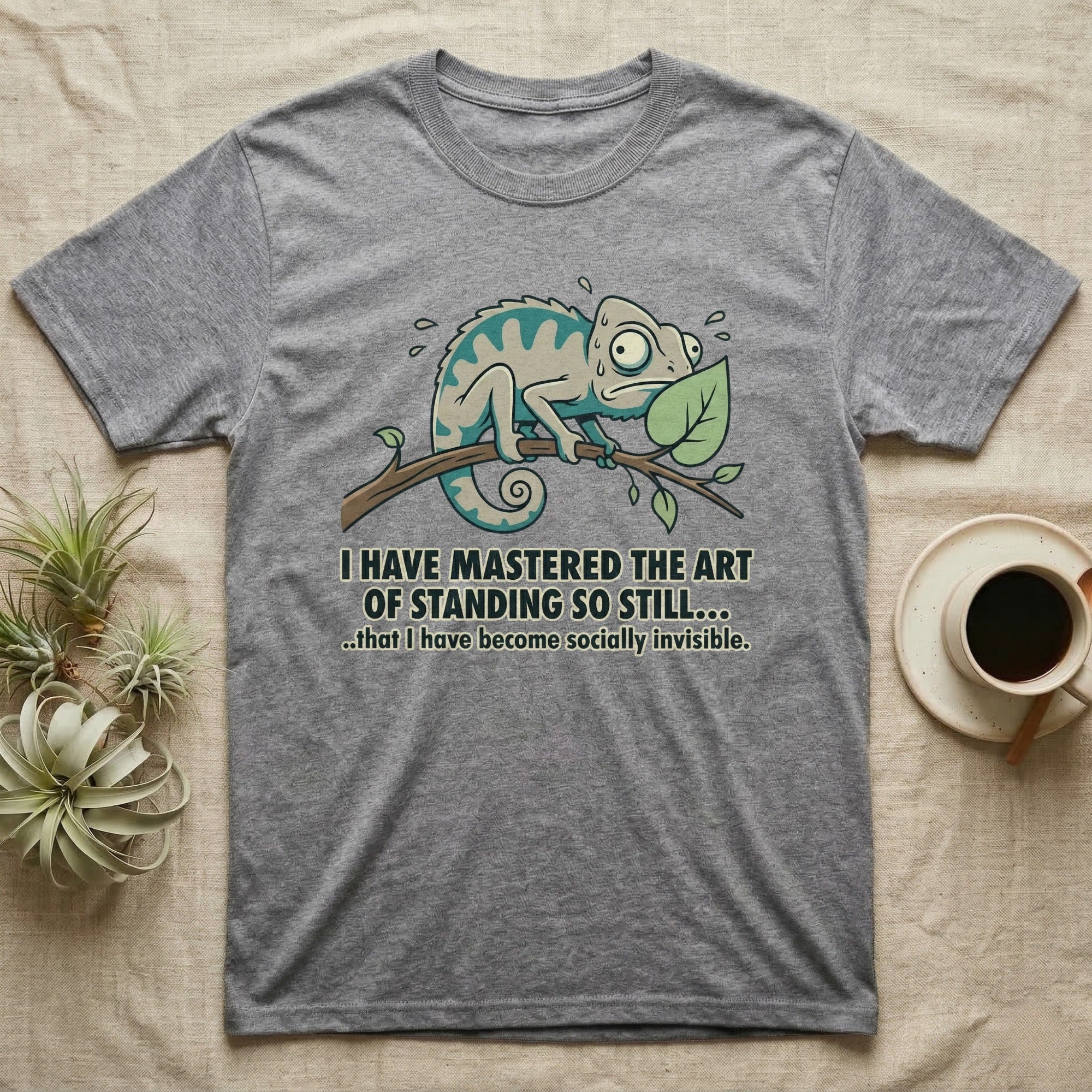 T-shirt with cartoon chameleon on a branch, text "I HAVE MASTERED THE ART OF STANDING SO STILL... ..that I have become socially invisible."