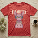 Red t-shirt with a Sphynx cat wearing glasses and jewelry, text "UNBOTHERED".