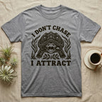 Alligator Snapper Lure T-Shirt in Sport Grey — Folk-print alligator snapping turtle, jaws open, tongue lure out, a fish swimming in, text I Don't Chase I Attract