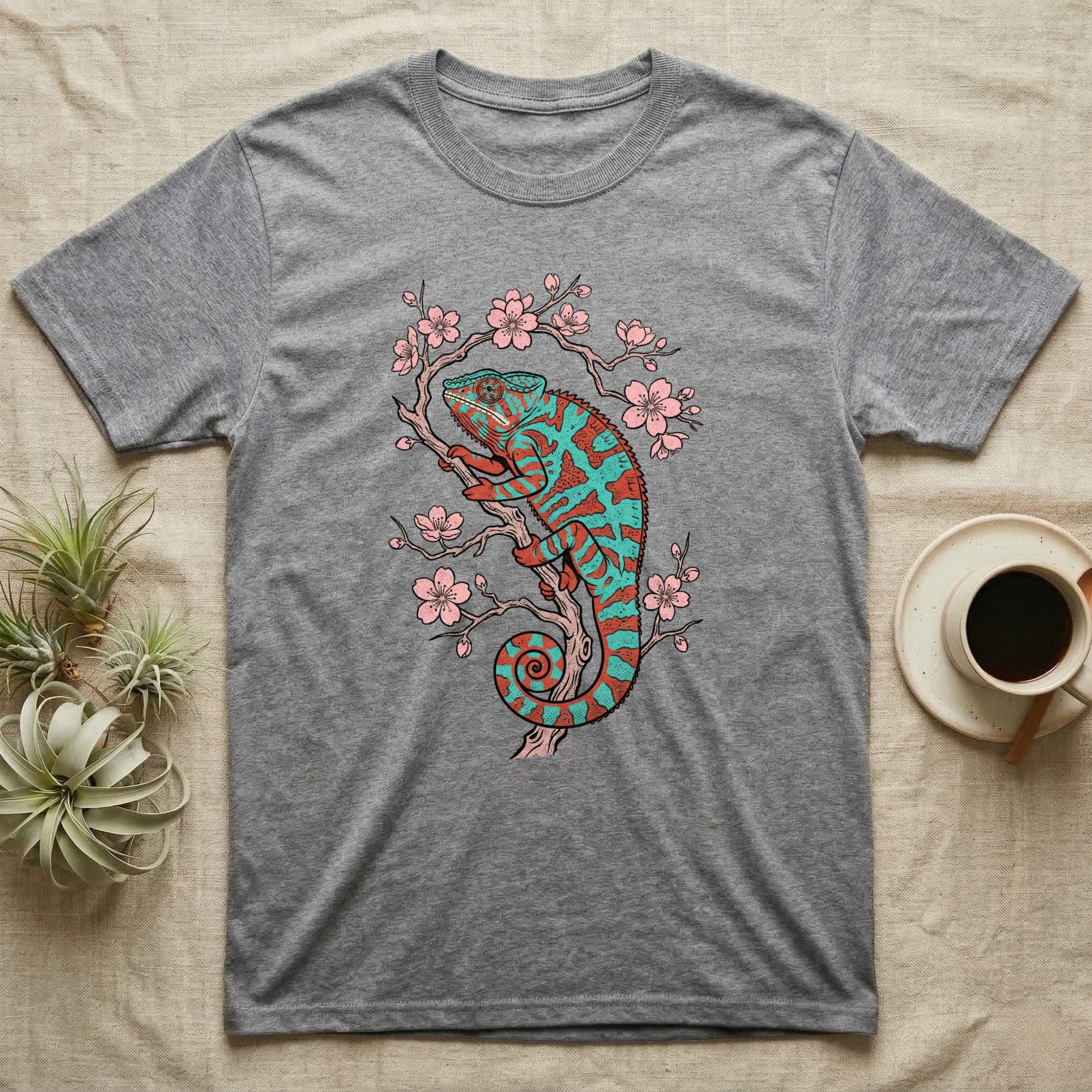 Grey t-shirt with a coral and teal chameleon on a cherry blossom branch.