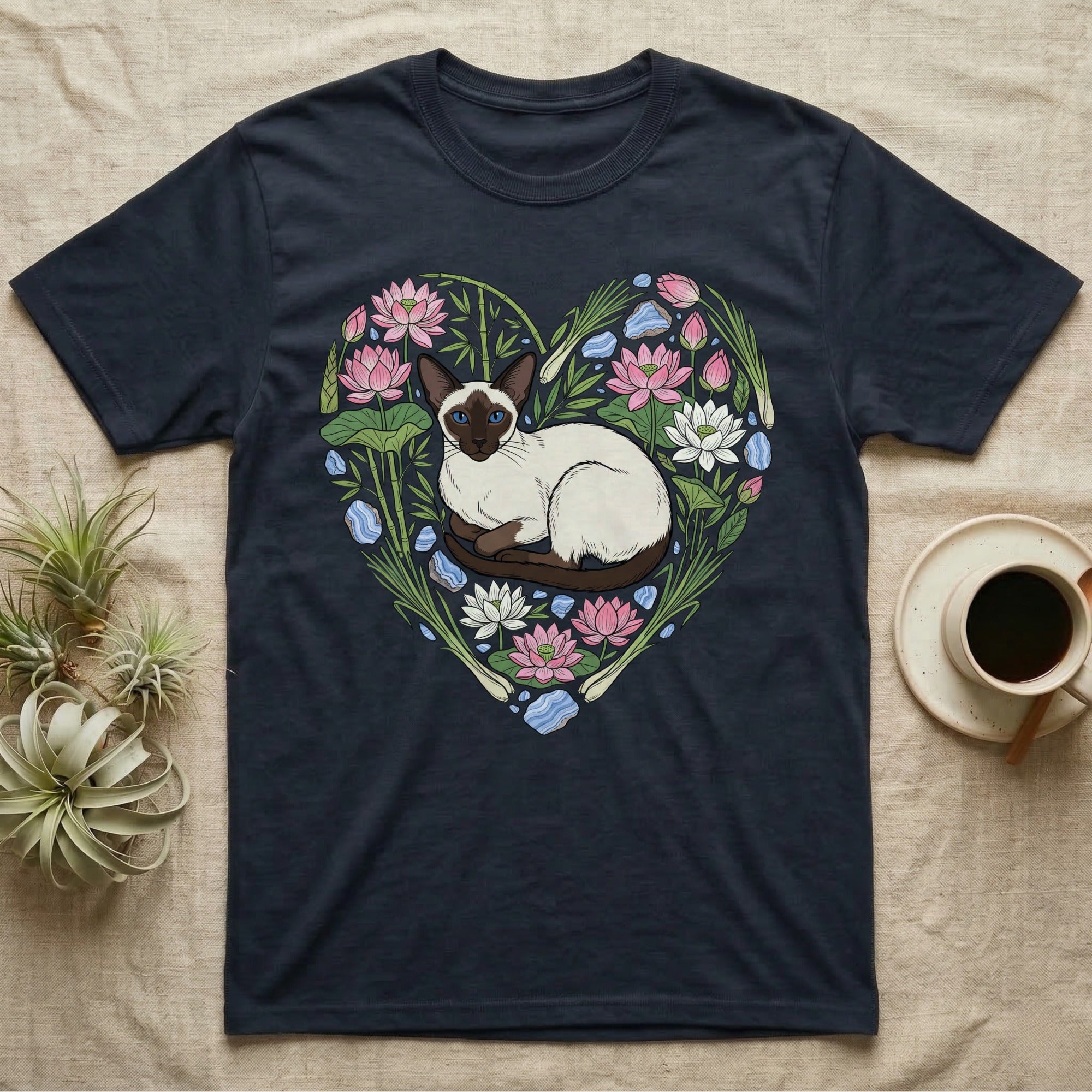 Dark t-shirt with a Siamese cat surrounded by lotus flowers forming a heart.