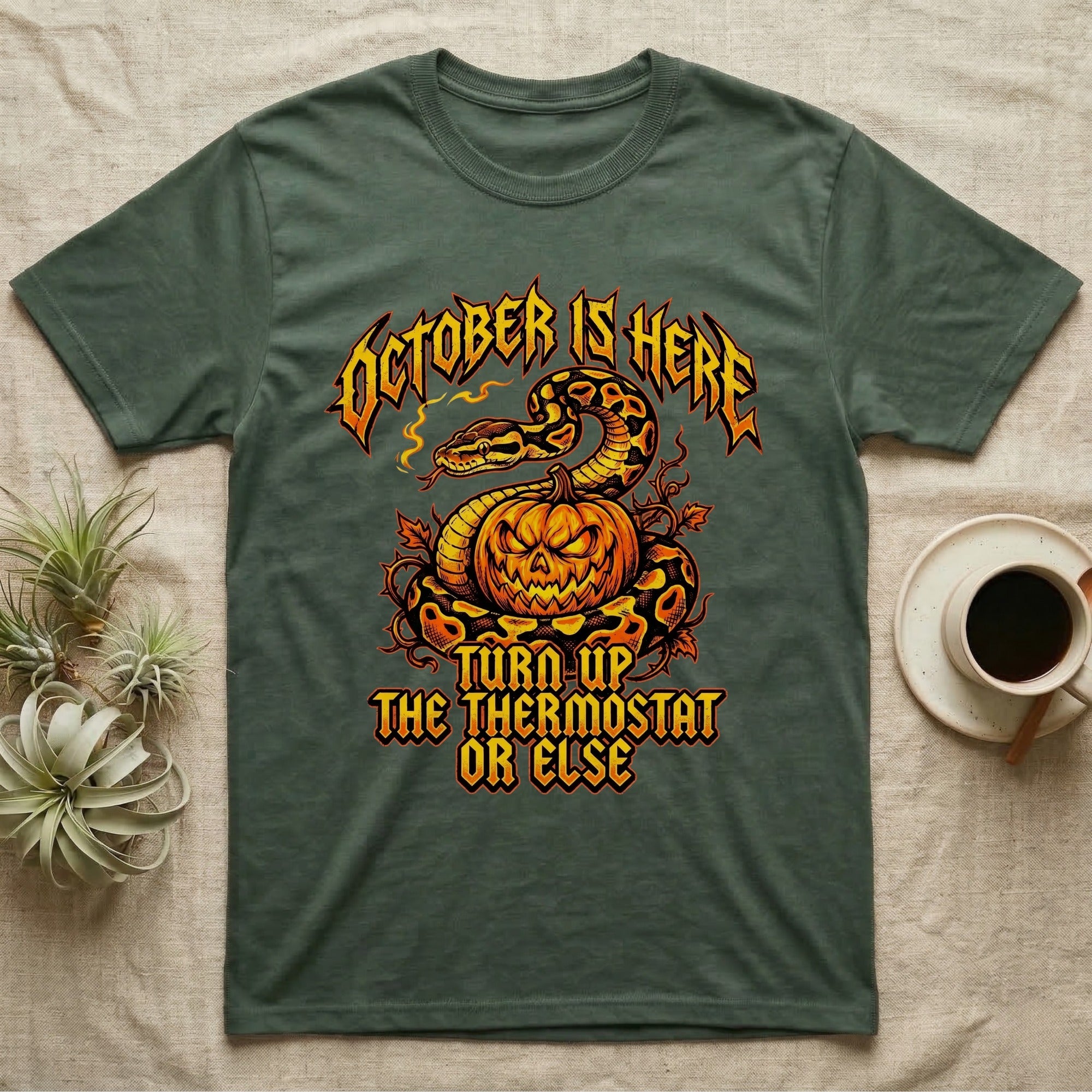 Ball Python October Thermostat T-Shirt in Military Green — Metal-band style ball python coiled over a glowing jack-o'-lantern, "October Is Here, Turn Up the Thermostat Or Else."