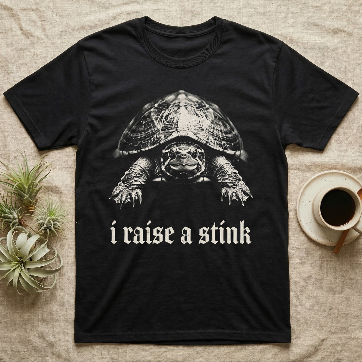 Musk Turtle Stink T-Shirt in Black — Photo of a small musk turtle facing forward above the blackletter line i raise a stink