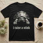 Musk Turtle Stink T-Shirt in Black — Photo of a small musk turtle facing forward above the blackletter line i raise a stink