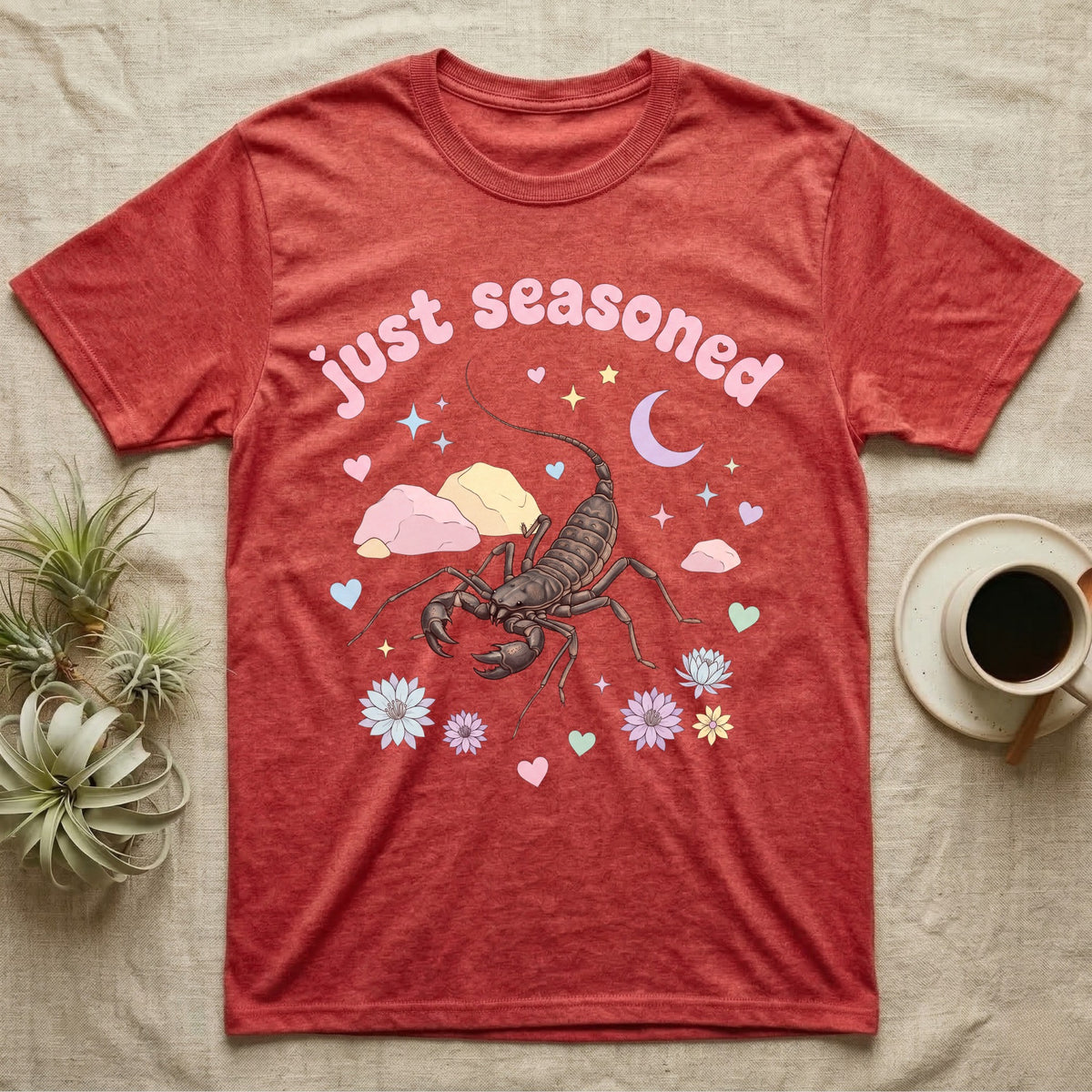 Giant Vinegaroon Baby T-Shirt in Heather Red — Pastel giant vinegaroon with pincers and whip tail among rocks and a crescent moon, puffy pink wordmark "just seasoned" above.