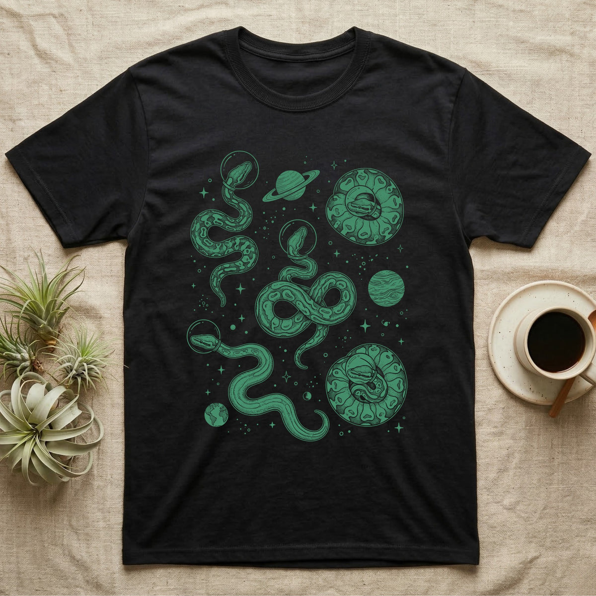 Ball Python Cosmic T-Shirt in Black — Vintage screen-print illustration of ball pythons in astronaut helmets floating in space, deep emerald green monochromatic on dark background.