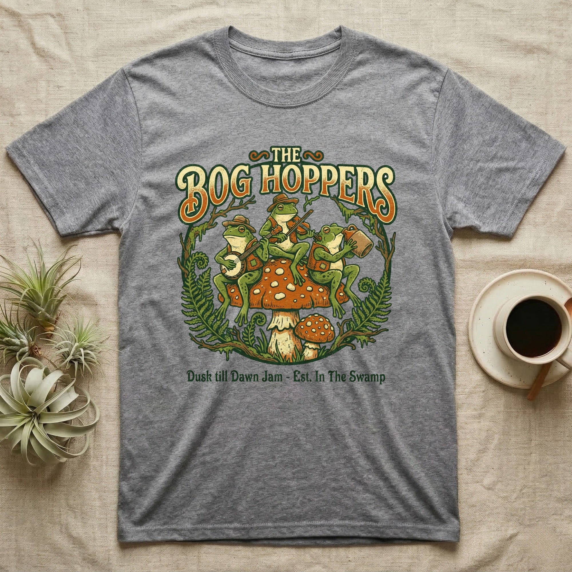 The Bog Hoppers t-shirt with frogs playing instruments on a mushroom.