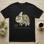 Unbothered Chameleon T-Shirt in Black — Ukiyo-e woodblock illustration of a veiled chameleon mid-chew with a deadpan serif caption beneath the subject.