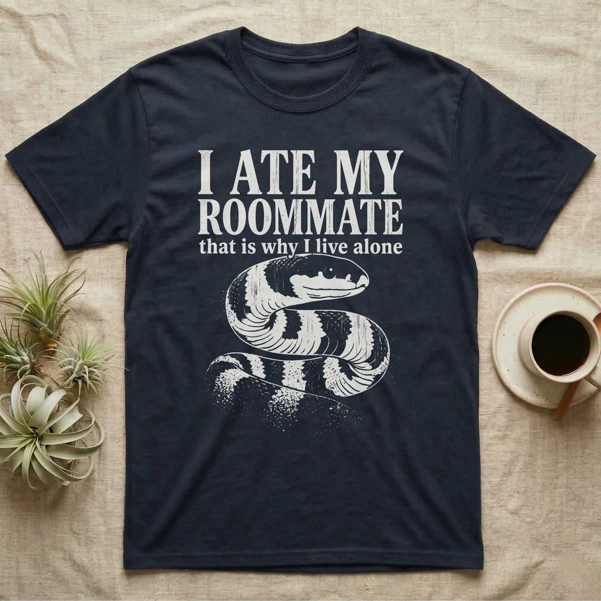 California Kingsnake Ate My Roommate T-Shirt in Navy — One-ink white California kingsnake portrait on black, black-and-cream banding, under the words I ATE MY ROOMMATE and that is why I live alone.
