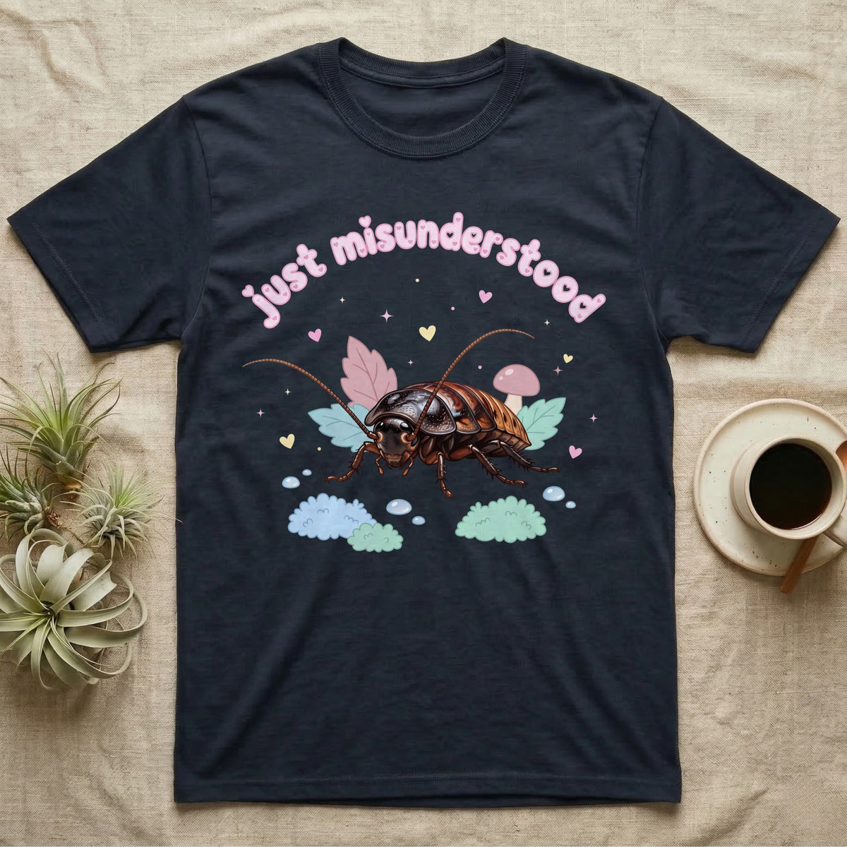 Madagascar Hissing Cockroach Baby T-Shirt in Navy — Pastel Madagascar hissing cockroach among leaves, mushroom and moss, puffy pink wordmark "just misunderstood" above.