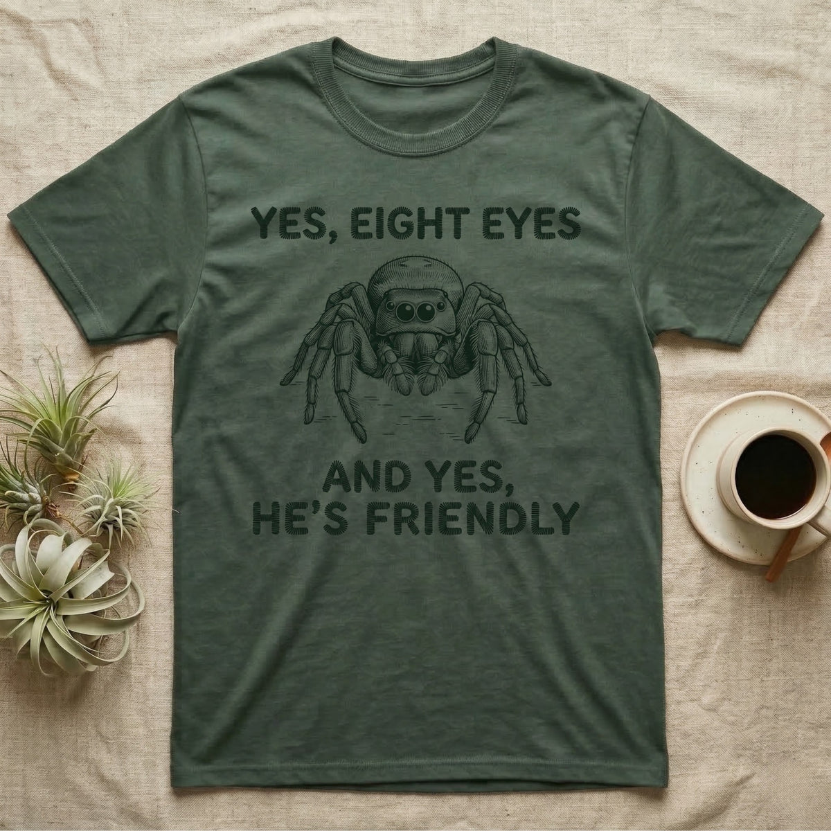 Jumping Spider Eight Eyes T-Shirt in Military Green — Engraved jumping spider head-on with large forward eyes, between stitch-look lettering on grey.