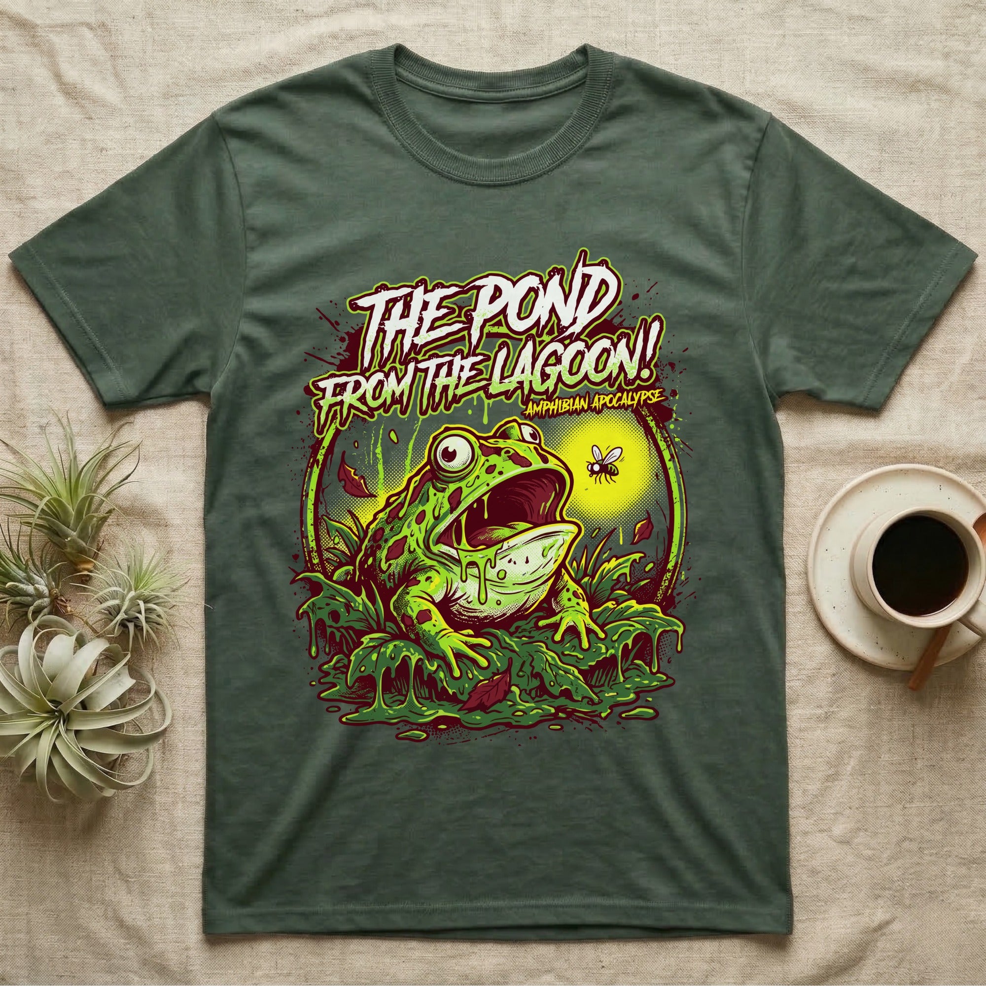 Pacman Frog Lagoon Apocalypse T-Shirt in Military Green — B-movie horror poster of a Pacman frog bursting from slime at a fly, "The Pond From the Lagoon, Amphibian Apocalypse."