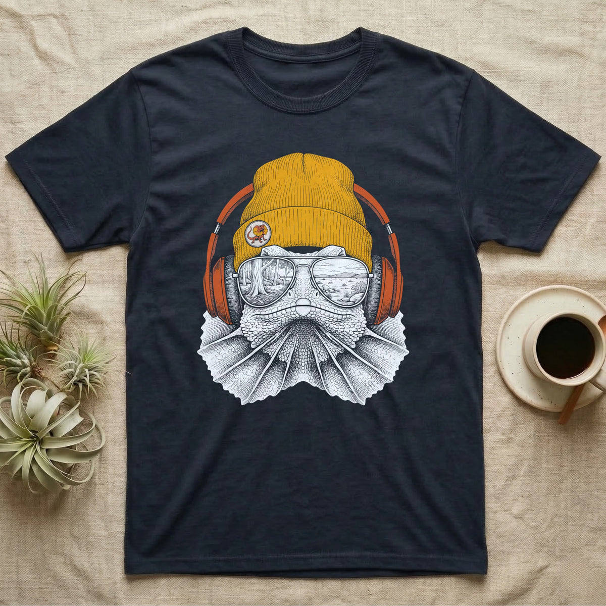 Frilled Lizard Headphones T-Shirt in Navy — Engraved frilled lizard with fanned frill in a beanie and headphones, aviators reflecting savannah woodland.