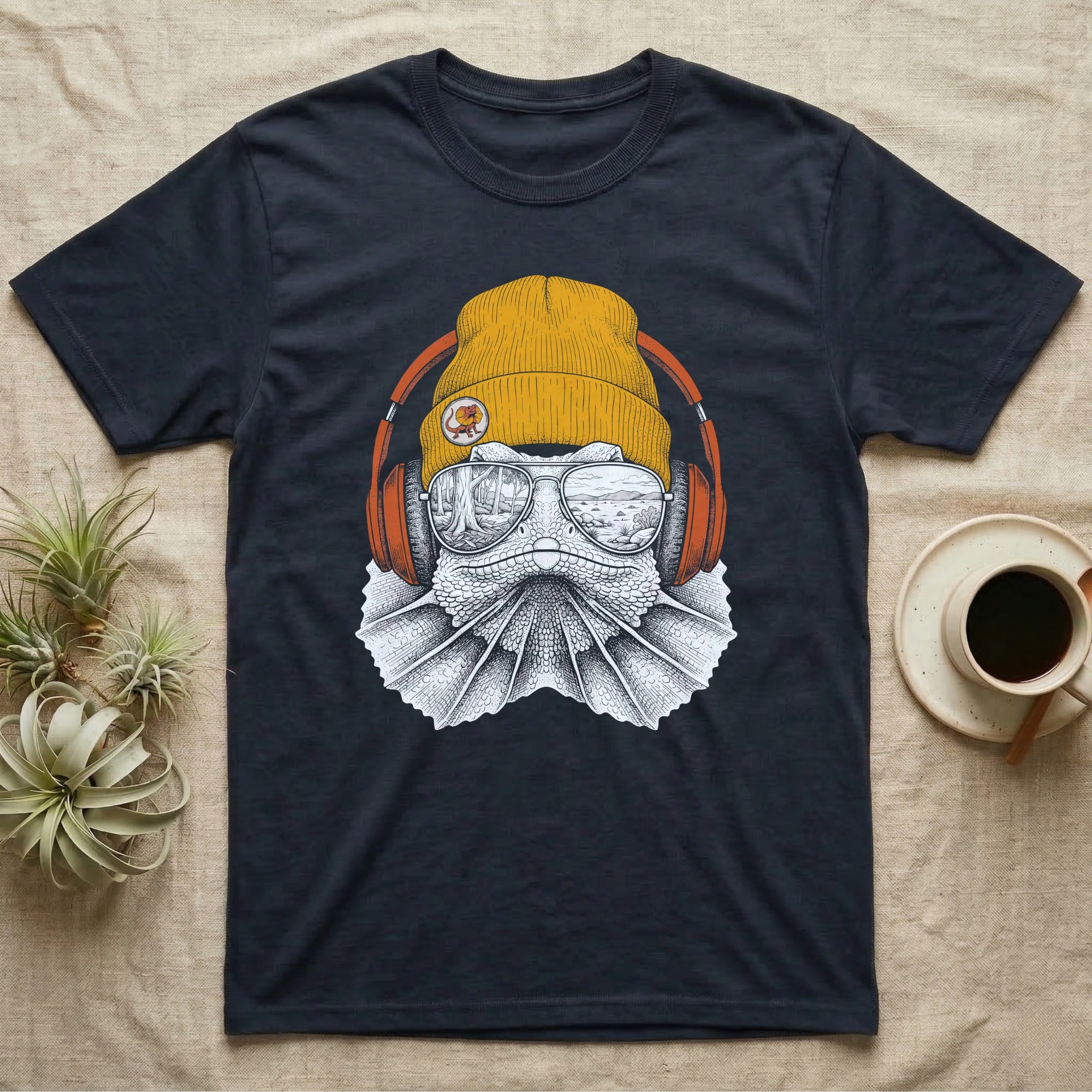 Frilled Lizard Headphones T-Shirt in Navy — Engraved frilled lizard with fanned frill in a beanie and headphones, aviators reflecting savannah woodland.