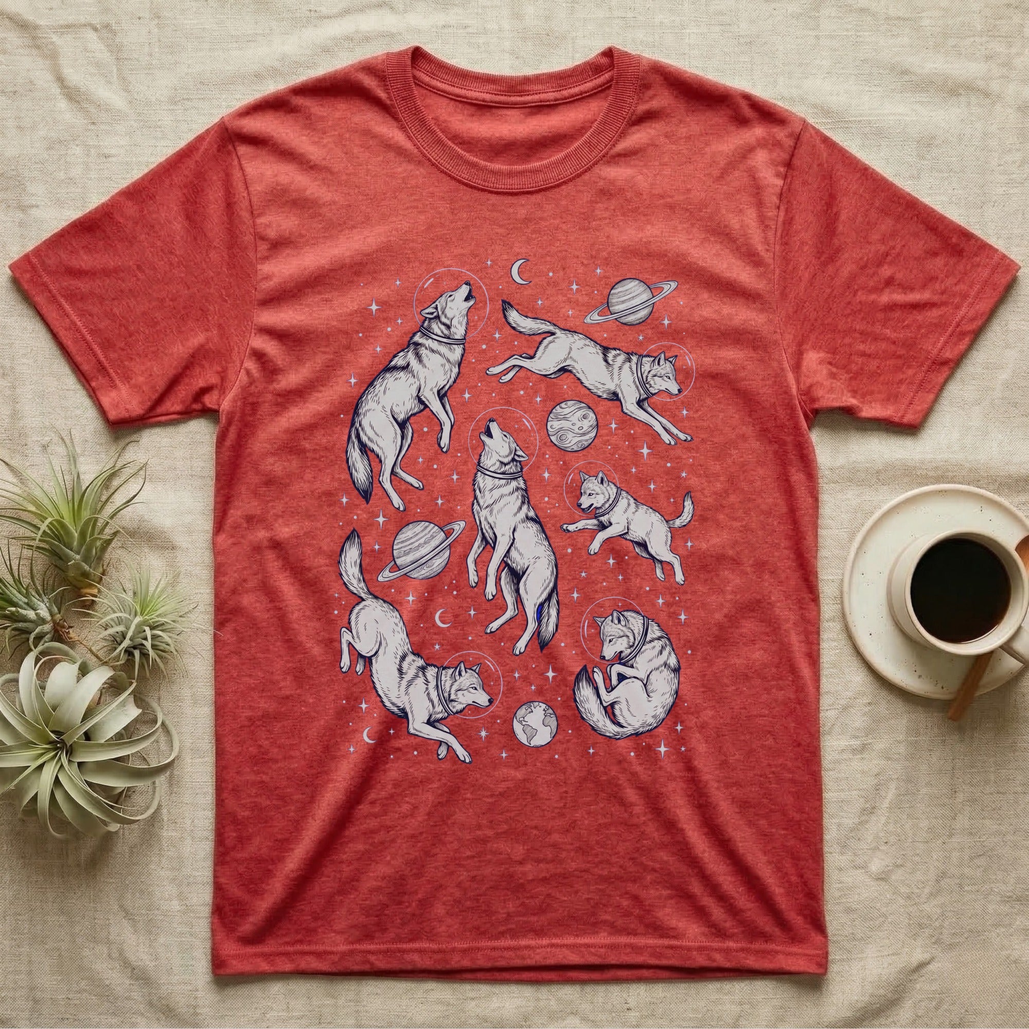 Red t-shirt with a repeating pattern of wolves in space among planets and stars.