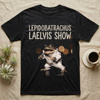 Budgett's Frog Rock Star T-Shirt in Black — Budgett's frog in a white rhinestone stage jumpsuit singing into a microphone under a Lepidobatrachus Laelvis Show headline.