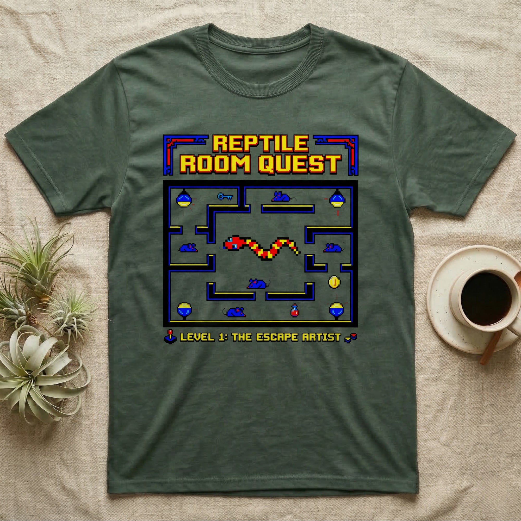 Green t-shirt with pixelated "Reptile Room Quest" and "Level 1: The Escape Artist" game graphic.