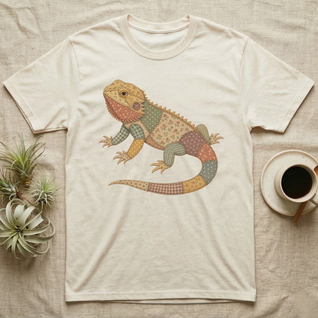 Beige t-shirt with a patchwork lizard graphic.