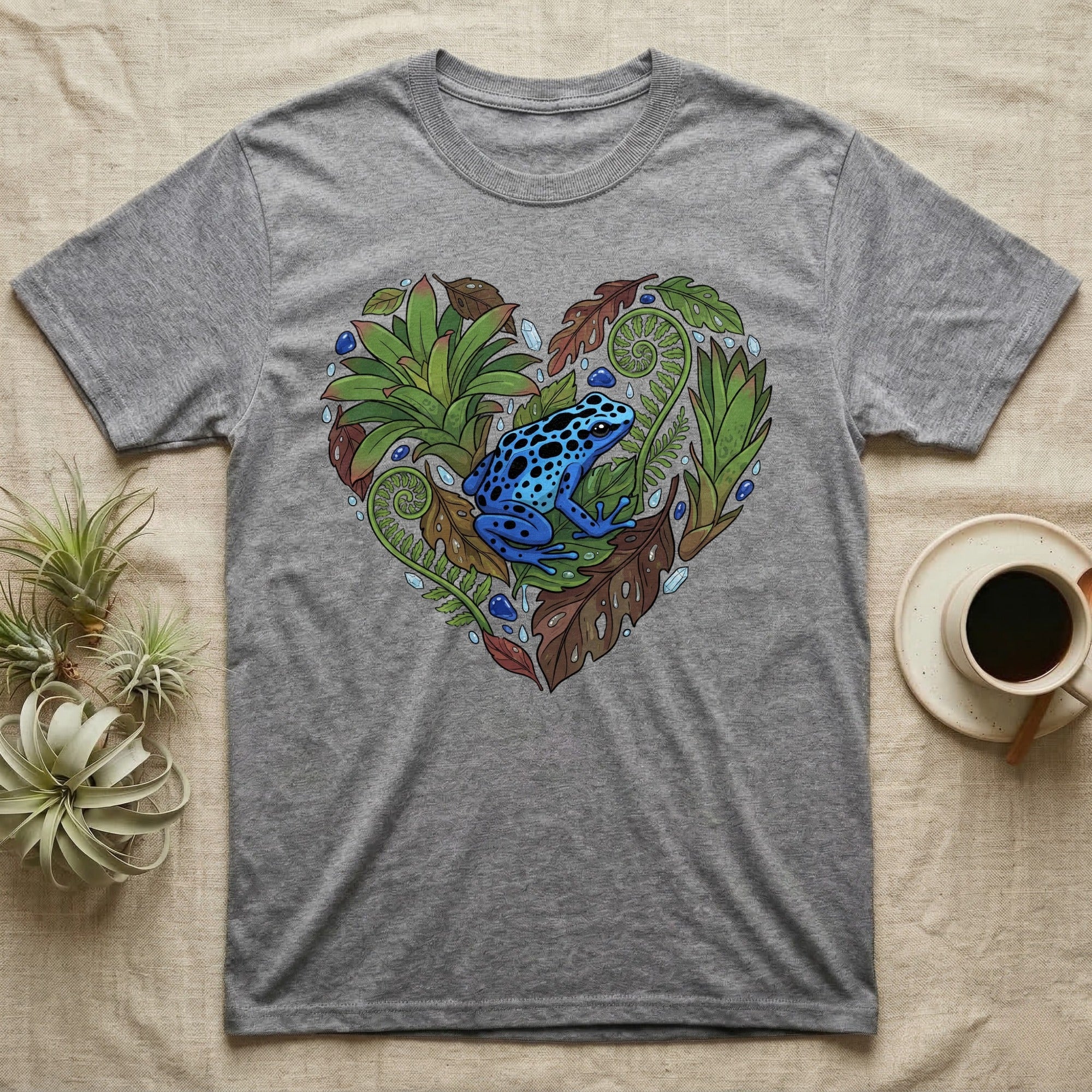 Grey t-shirt with a blue poison dart frog surrounded by leaves and water droplets.
