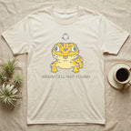 Cream t-shirt with yellow cartoon gecko and "BRAIN CELL NOT FOUND" text.