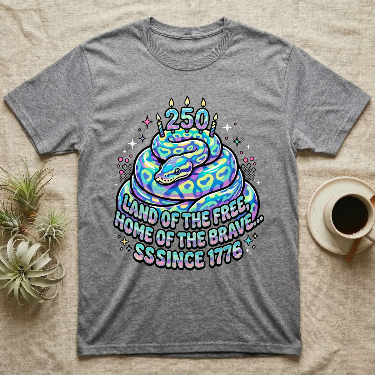 Ball Python Birthday Cake T-Shirt in Sport Grey — Y2K pastel ball python coiled as a birthday cake with 250 candles and bubble text Land of the Free, Sssince 1776.