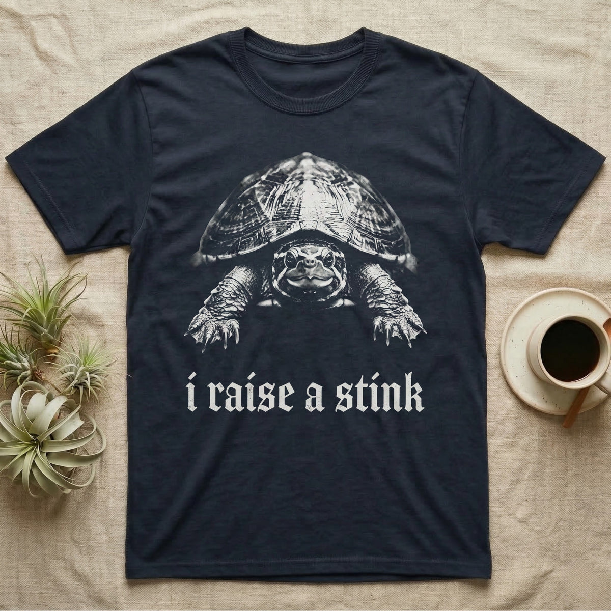 Musk Turtle Stink T-Shirt in Navy — Photo of a small musk turtle facing forward above the blackletter line i raise a stink